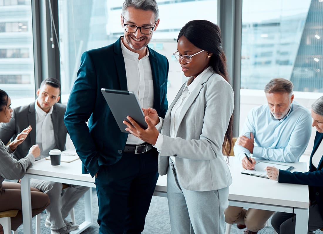 Ridgeland, MS - Two Business Professionals Looking at a Tablet