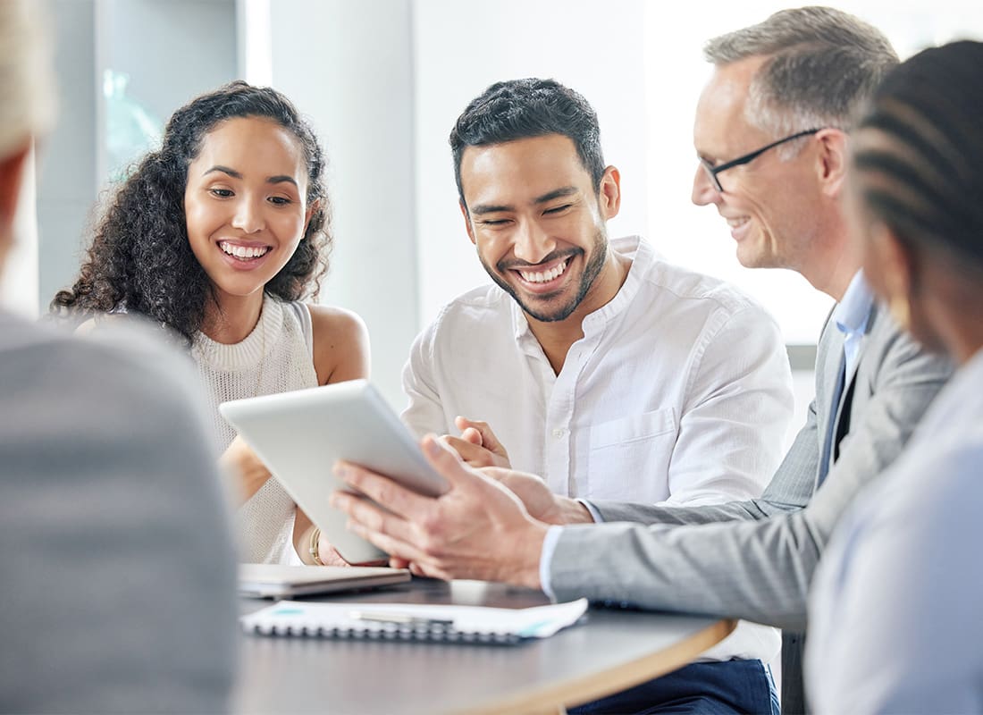 Corinth MS - Office Meeting Business Group Reviewing Tablet