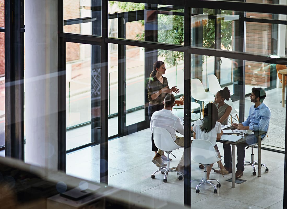 Oxford, MS - Group of Professional Business People Having a Meeting